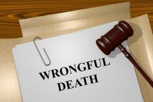 A folder containing paperwork labeled "wrongful death," with a wooden gavel resting on top.