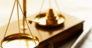 Golden scales of justice on a desktop.