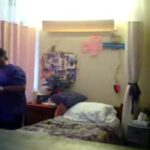 A nursing home resident cowers in fear as a staff member approaches. Screenshot from hidden camera footage.
