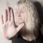 A woman holds out her hand.