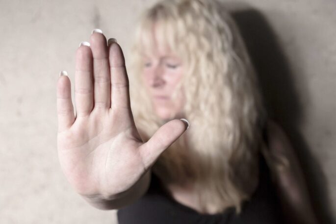 A woman holds out her hand.