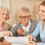 young woman sitting at table with two elderly people