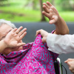 an older woman about to get hit by a man