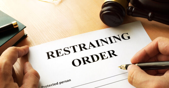 someone signing a restraining order