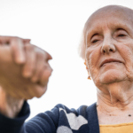 an older woman holding another person's hand