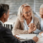 an older couple reviews documents with a younger professional