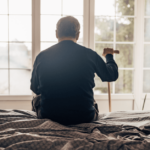 Nursing home resident alone looking out window